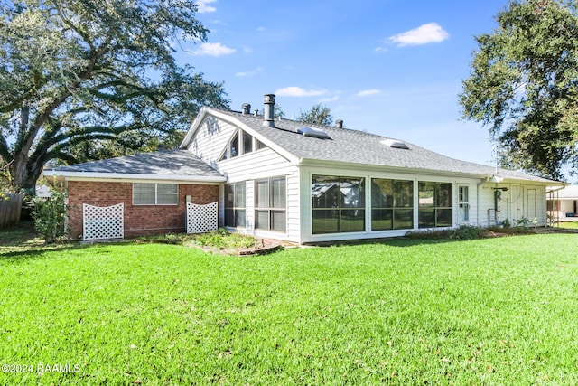 back of property featuring a yard