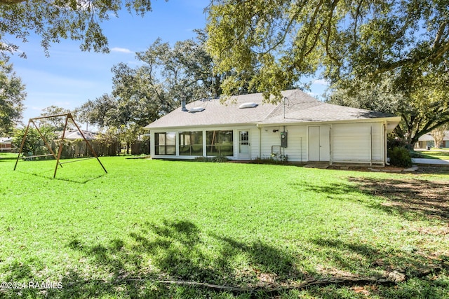 view of front of house with a sunroom and a front yard