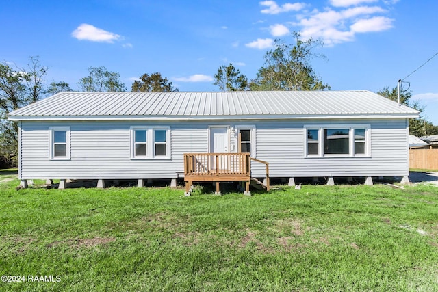 rear view of property with a yard