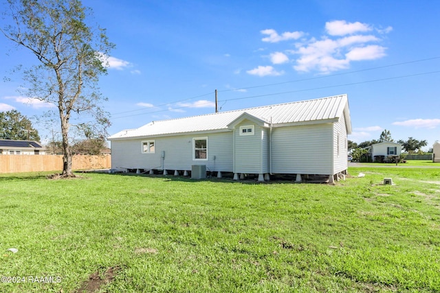 back of property featuring a yard and central AC unit