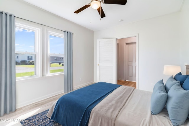 bedroom with ceiling fan and light hardwood / wood-style flooring