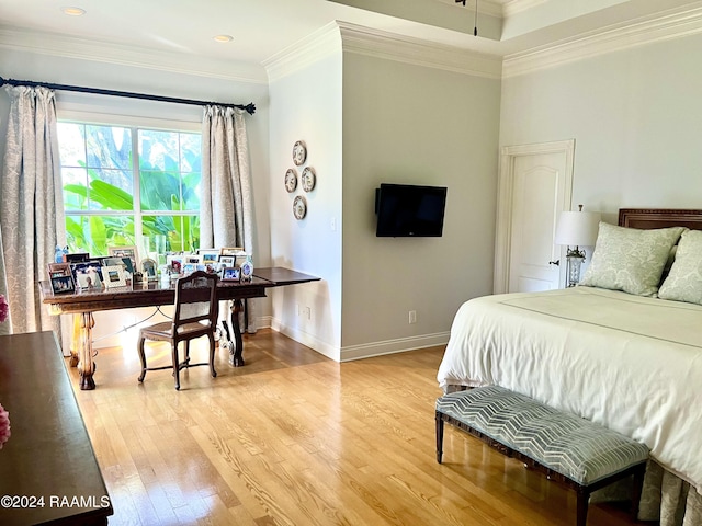 bedroom with light hardwood / wood-style floors and ornamental molding