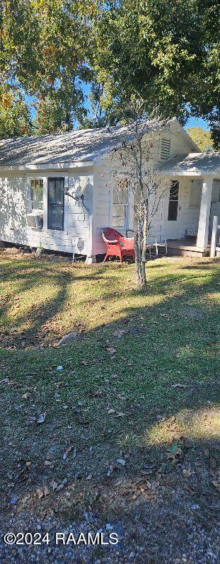 back of house featuring a yard