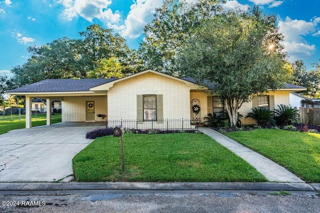 single story home featuring a carport and a front yard