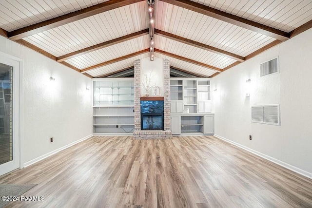 unfurnished living room featuring vaulted ceiling with beams, built in features, light hardwood / wood-style floors, and a brick fireplace