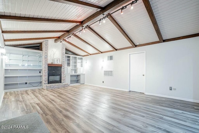 unfurnished living room with beam ceiling, a brick fireplace, built in features, high vaulted ceiling, and hardwood / wood-style flooring