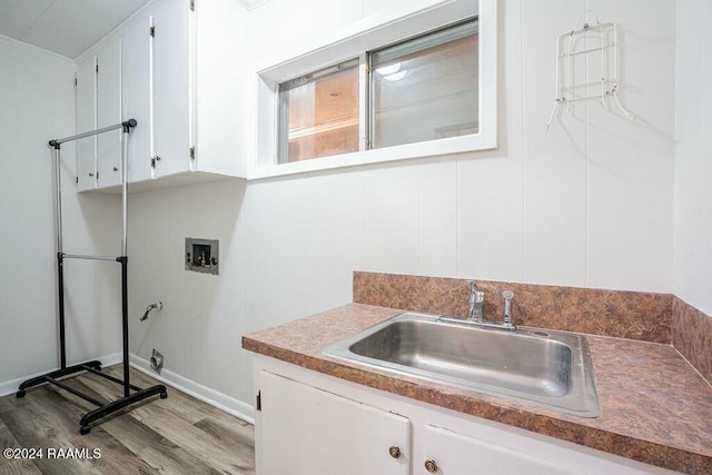 washroom with hookup for a washing machine, light hardwood / wood-style flooring, and sink