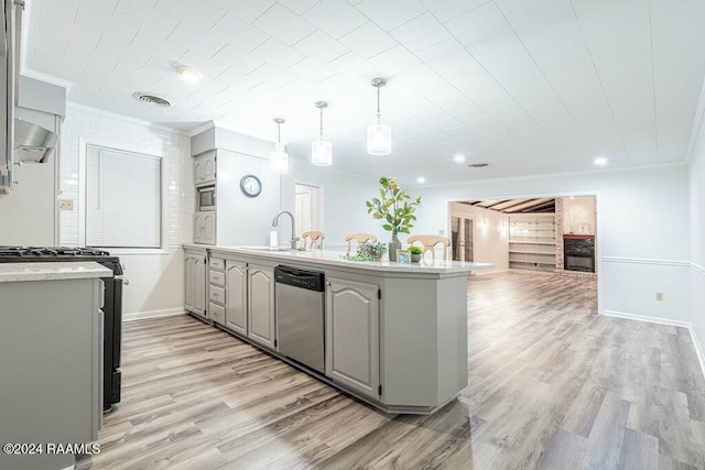 kitchen with gray cabinetry, dishwasher, sink, gas range oven, and light wood-type flooring