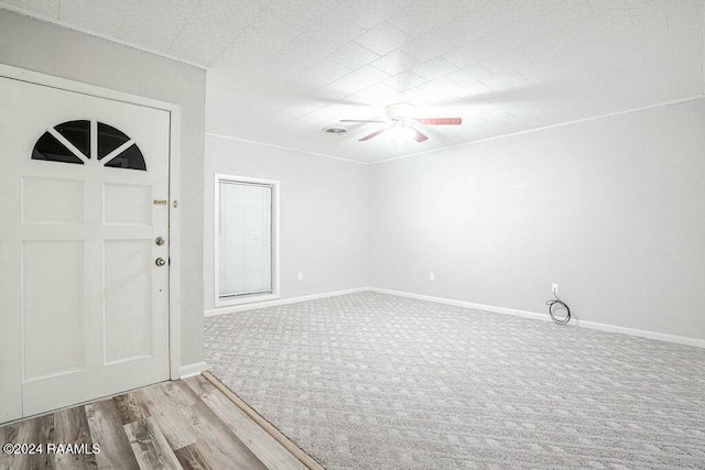 entrance foyer with ceiling fan and light wood-type flooring