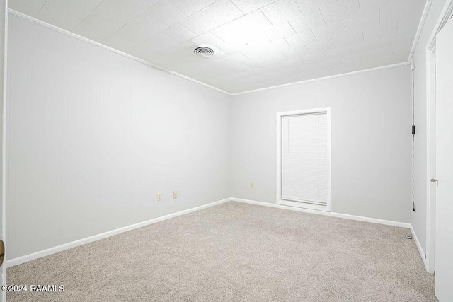 empty room with carpet flooring and crown molding