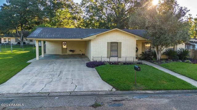 ranch-style home with a carport and a front lawn