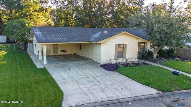 single story home featuring a carport and a front lawn