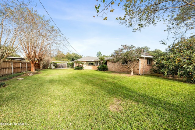 227 Meadow Ln, Lafayette, LA 70506 - view of yard featuring a carport