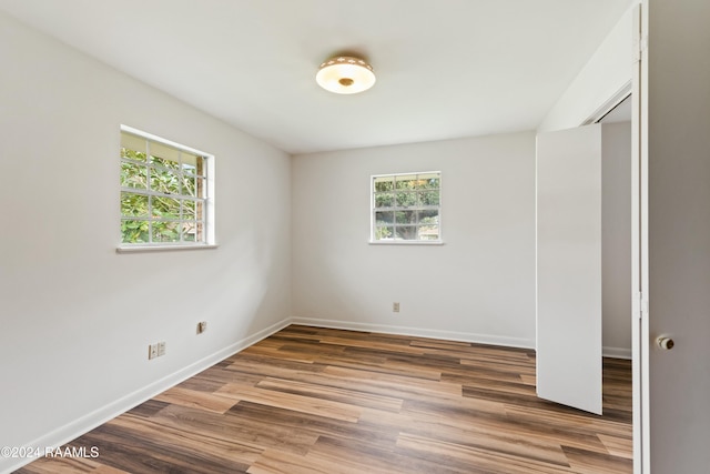 spare room with wood-type flooring