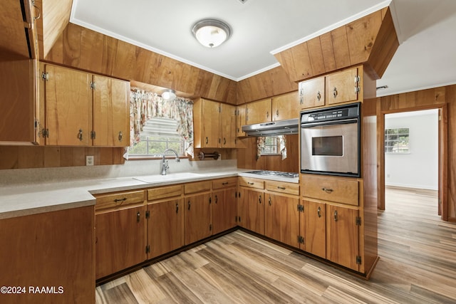 kitchen featuring white gas cooktop, stainless steel oven, light wood-type flooring, and sink