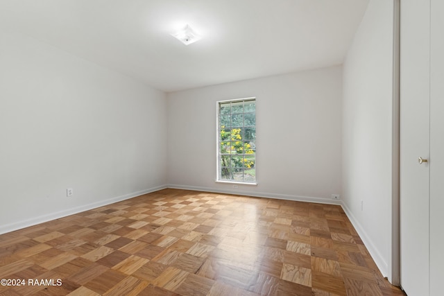 unfurnished room with light parquet flooring