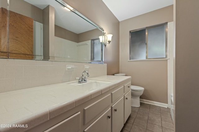 227 Meadow Ln, Lafayette, LA 70506 - bathroom featuring vanity, toilet, tile patterned floors, decorative backsplash, and a shower
