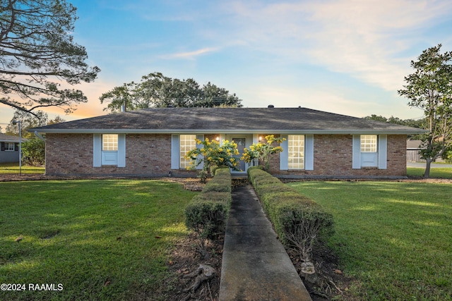 227 Meadow Ln, Lafayette, LA 70506 - ranch-style house with brick siding and a yard