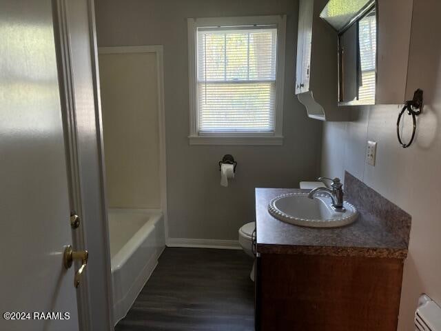 bathroom with vanity, toilet, and wood-type flooring