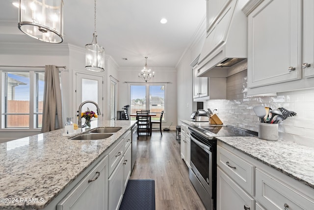 108 Timber Bark Rd, Lafayette, LA 70508 - kitchen featuring a sink, appliances with stainless steel finishes, premium range hood, a chandelier, and tasteful backsplash