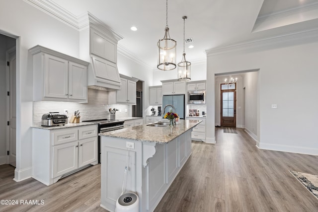 108 Timber Bark Rd, Lafayette, LA 70508 - kitchen featuring built in appliances, a sink, a chandelier, an island with sink, and decorative backsplash