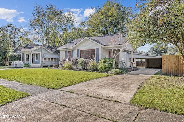 view of front of property with a front lawn and a carport