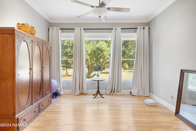 doorway to outside with light wood-type flooring, ceiling fan, and crown molding