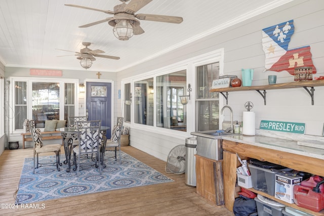 sunroom / solarium featuring ceiling fan and sink