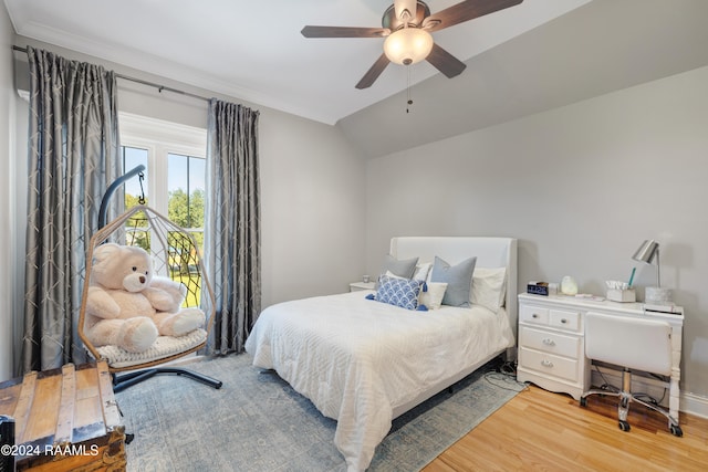 bedroom featuring light hardwood / wood-style floors, ceiling fan, and lofted ceiling