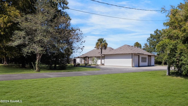 view of front of house with a garage and a front lawn