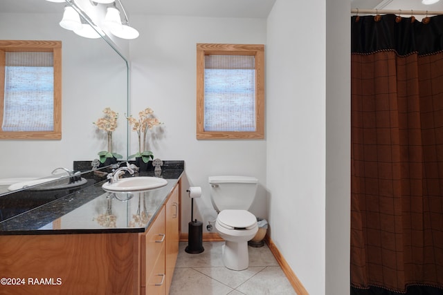 bathroom with tile patterned flooring, vanity, toilet, and curtained shower