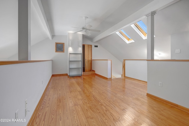 additional living space with light hardwood / wood-style flooring, lofted ceiling with skylight, and ceiling fan