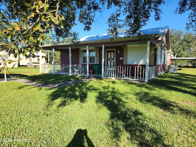 view of front of property with a porch and a front yard