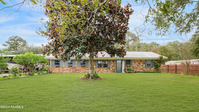 rear view of property featuring a yard