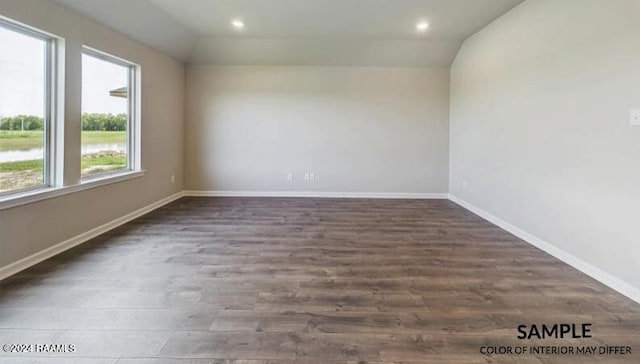 spare room with dark hardwood / wood-style floors and lofted ceiling