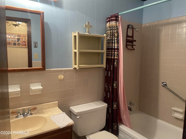 full bathroom featuring vanity, toilet, tile walls, and shower / tub combo with curtain