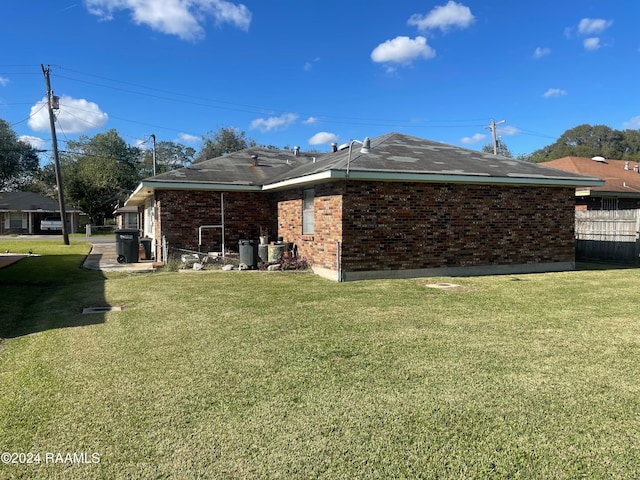 rear view of house featuring a yard