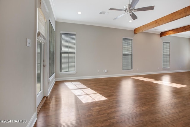 spare room featuring dark hardwood / wood-style flooring, crown molding, and a wealth of natural light