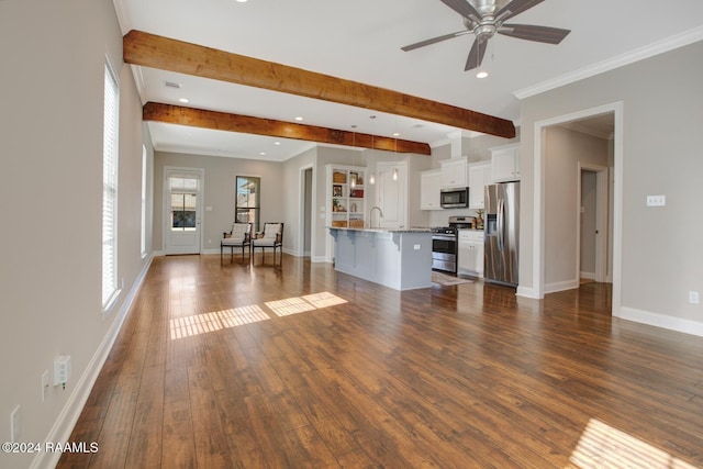 unfurnished living room featuring dark hardwood / wood-style flooring, ceiling fan, crown molding, sink, and beamed ceiling