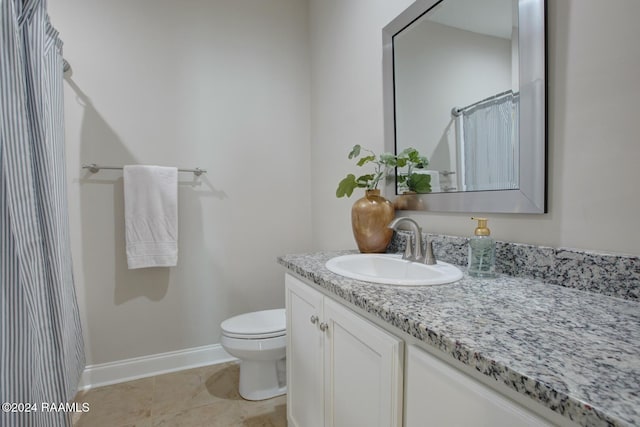 bathroom featuring tile patterned flooring, vanity, a shower with shower curtain, and toilet