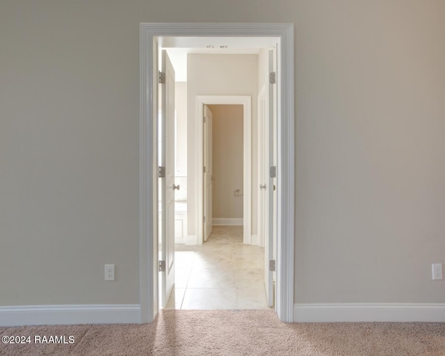 corridor featuring light carpet