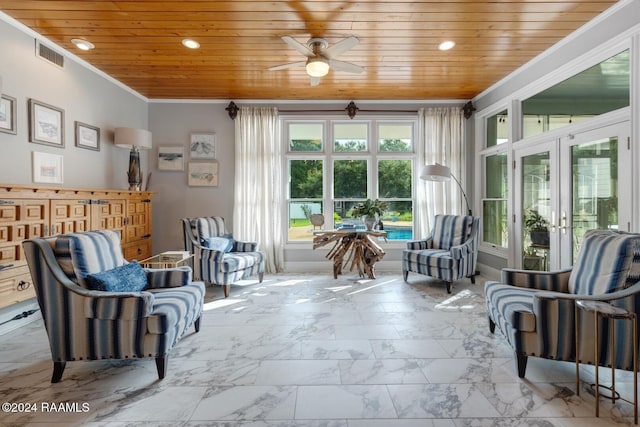 sitting room with ceiling fan, wooden ceiling, crown molding, and french doors