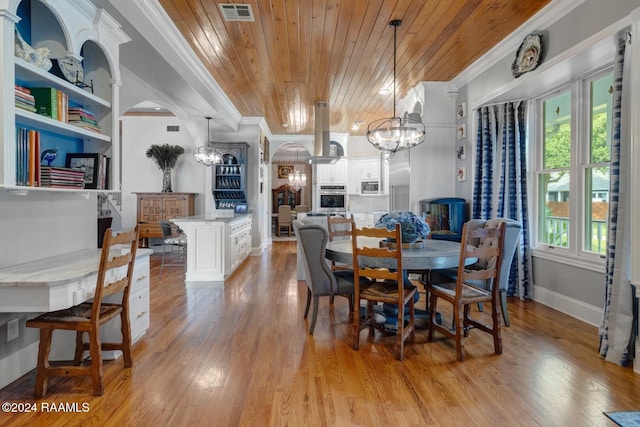 dining space featuring light hardwood / wood-style floors, an inviting chandelier, wooden ceiling, and crown molding