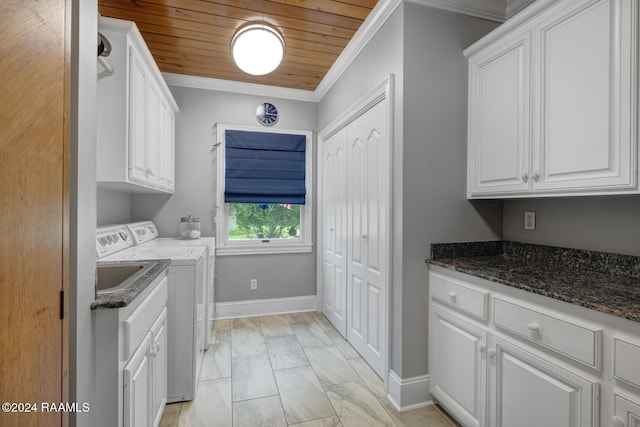 washroom with cabinets, ornamental molding, sink, wooden ceiling, and washing machine and clothes dryer