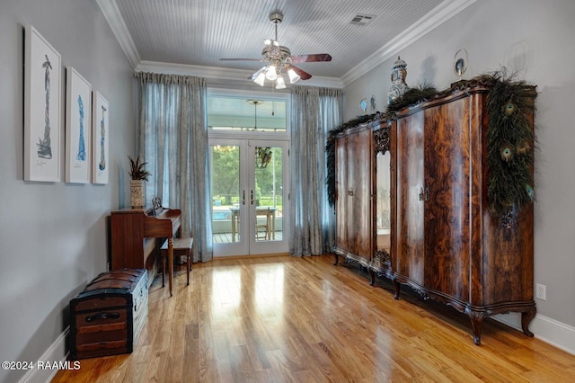 interior space featuring french doors, light hardwood / wood-style flooring, ceiling fan, and crown molding