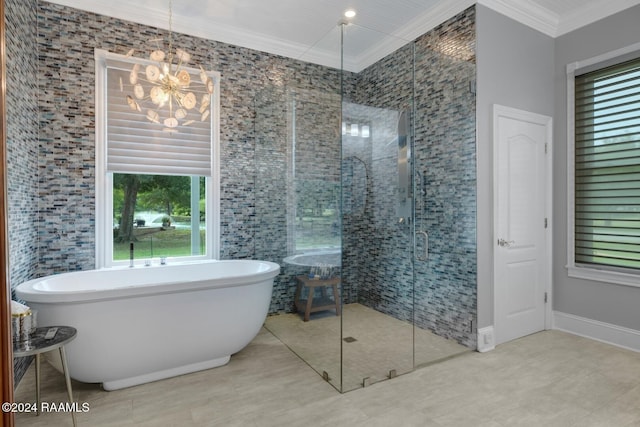 bathroom featuring ornamental molding, separate shower and tub, a wealth of natural light, and a notable chandelier