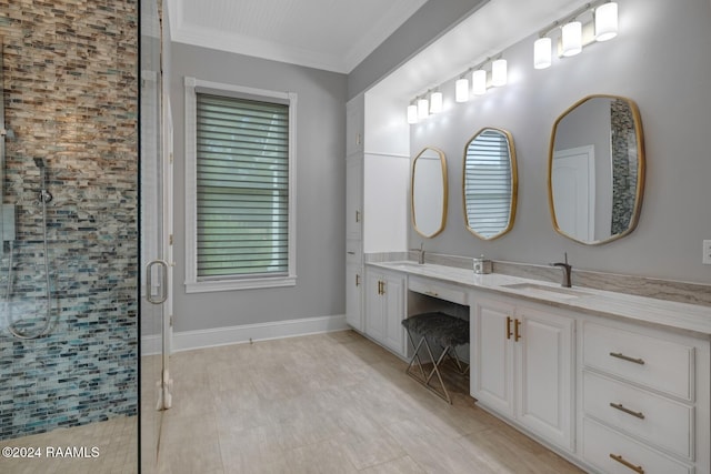 bathroom with crown molding, a shower with door, vanity, and a healthy amount of sunlight