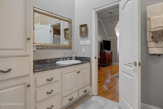 bathroom featuring hardwood / wood-style flooring and vanity