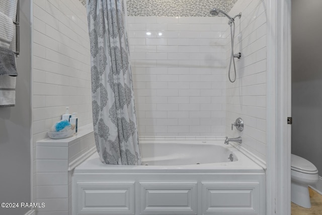 bathroom with shower / bath combo and toilet