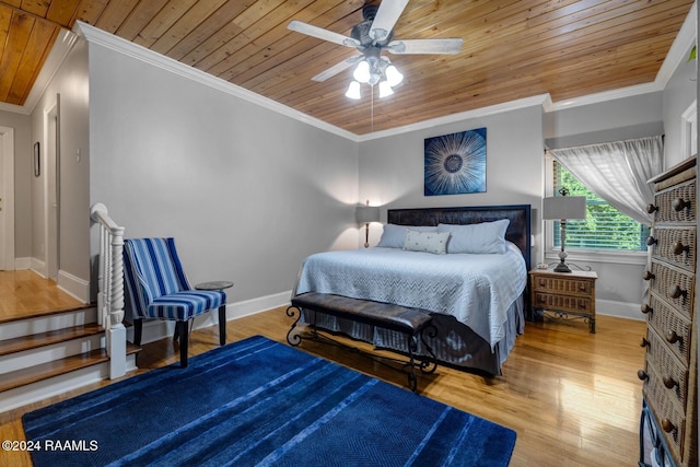 bedroom featuring light hardwood / wood-style flooring, ceiling fan, ornamental molding, and wood ceiling